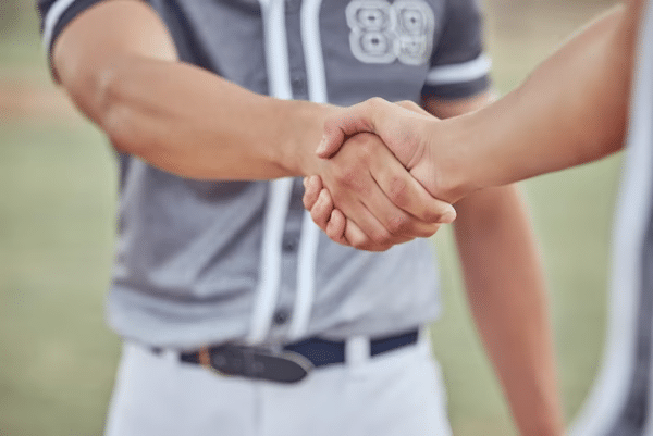 Athletes and Corporate Professionals Shaking Hands